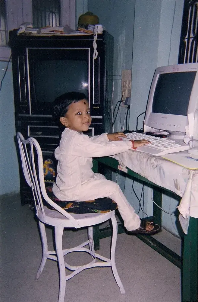 Adeen as a child at a desktop computer